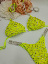 Load image into Gallery viewer, Neon green bikini set with rhinestone details on a white background with floral decorations.